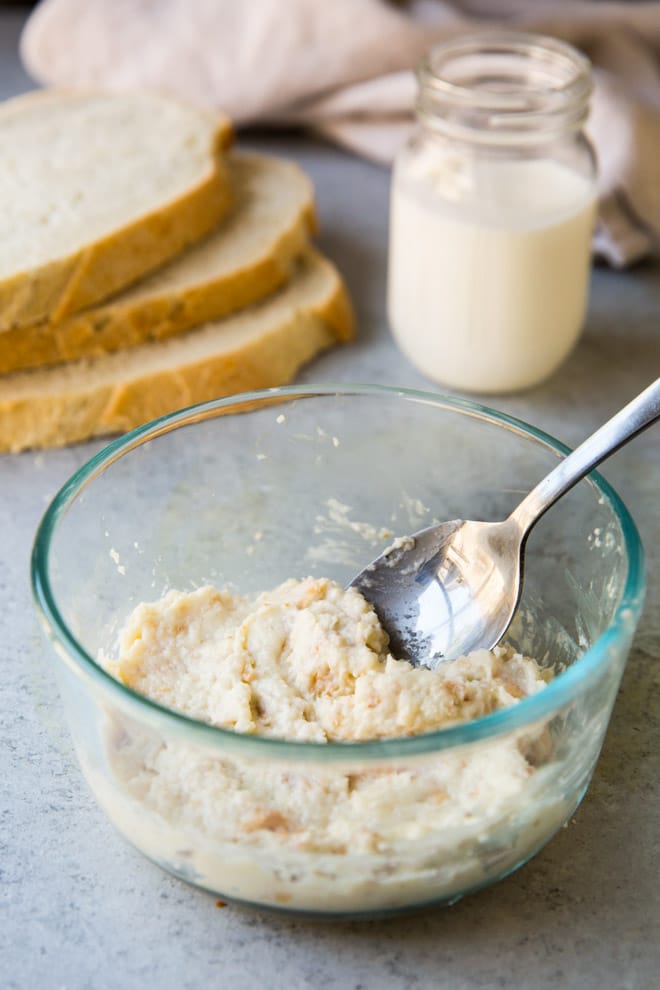 Panade in a clear bowl with a sliver spoon.