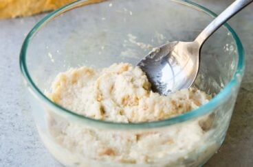 Panade in a clear bowl with a sliver spoon.
