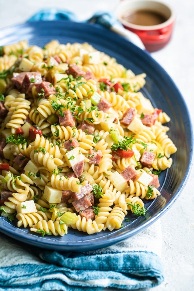 Italian pasta salad on a blue platter.