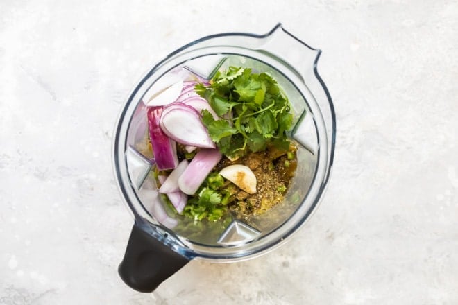 Tomatillo green chili salsa ingredients in a blender.
