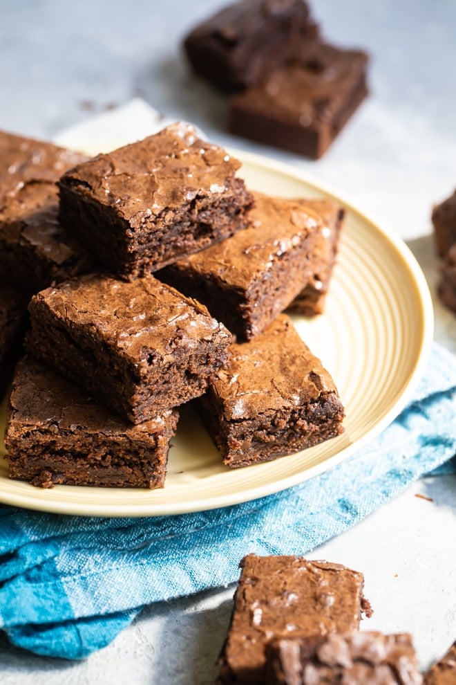 Brownie squares on a yellow circle plate.