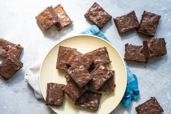 Brownie squares on a yellow circle plate.