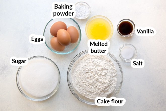 Labeled easy pound cake ingredients in various bowls.