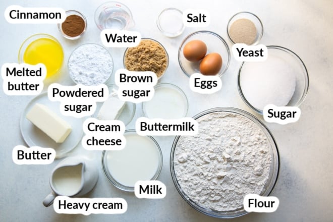 Labeled cinnamon roll ingredients in various bowls.