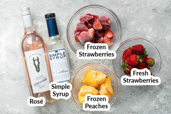 Strawberry peach frosé ingredients on a gray countertop.