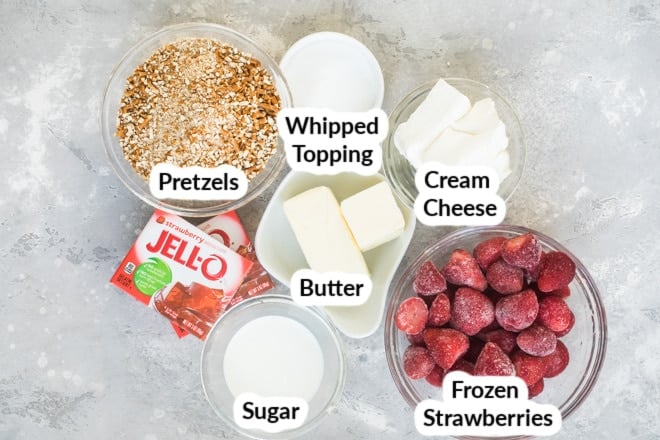 Labeled strawberry pretzel jello salad ingredients in various bowls.