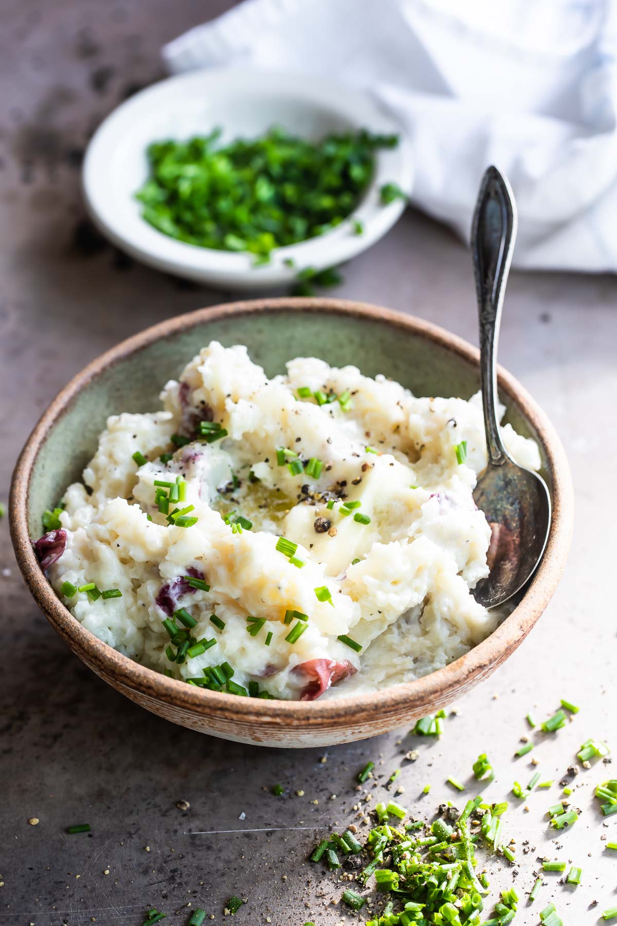 Boursin mashed potatoes in a light green bowl.