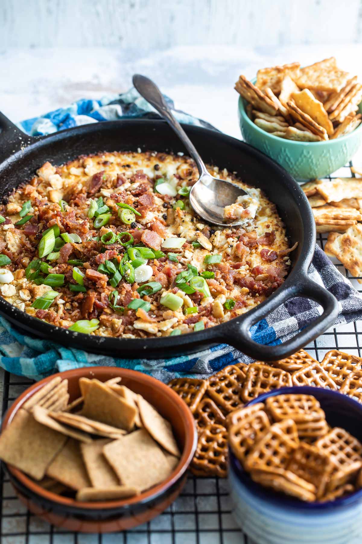 Cheesy bacon dip in a cast iron skillet.