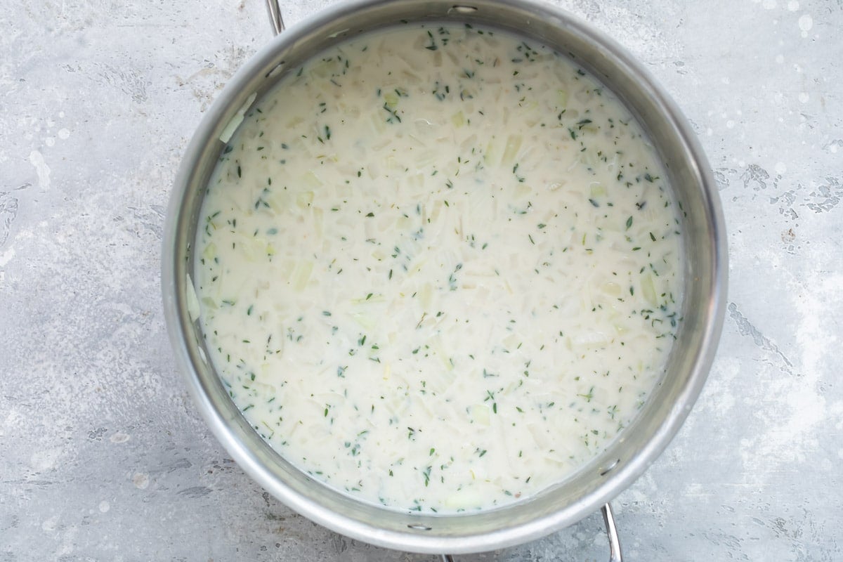 Chicken tetrazzini sauce in a silver stock pot.