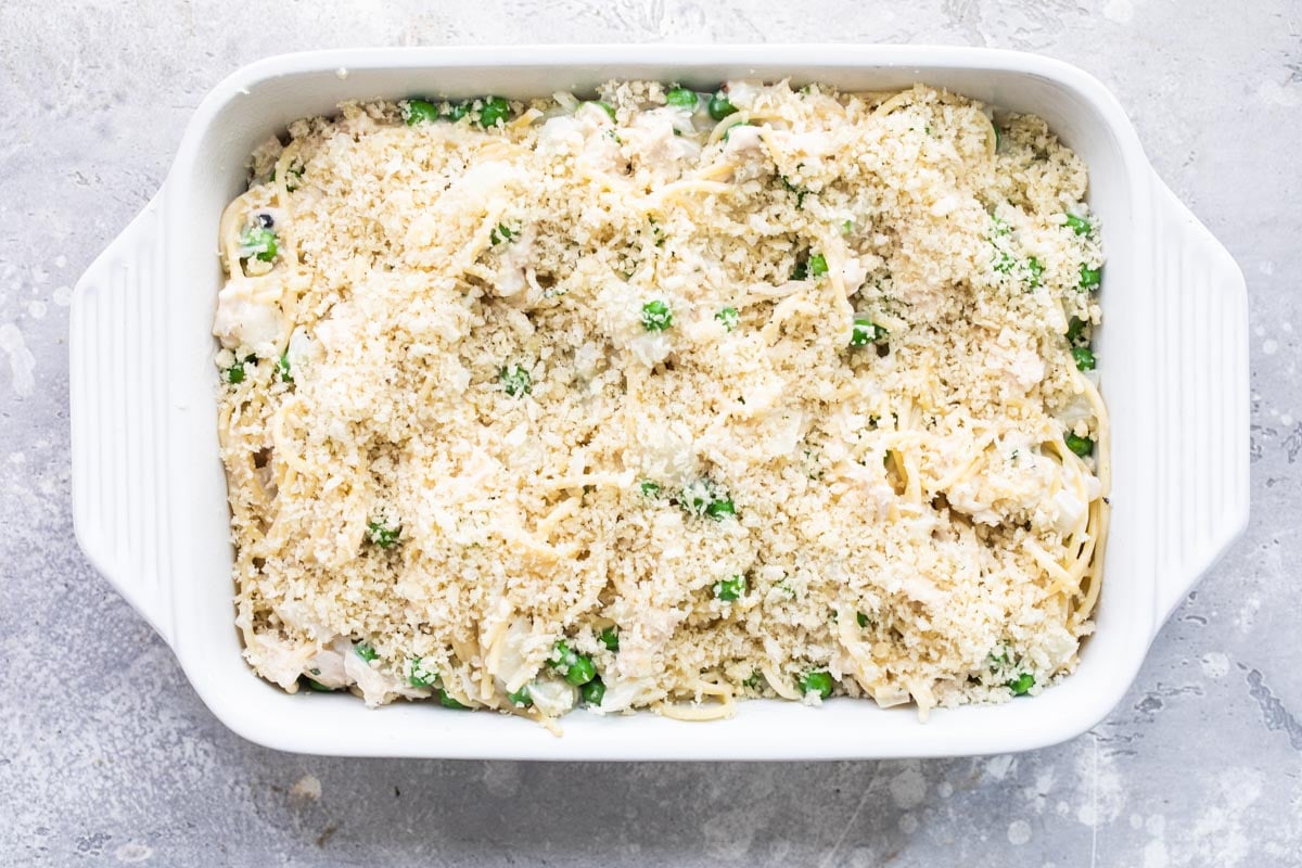 Unbaked chicken tetrazzini in a white casserole dish.