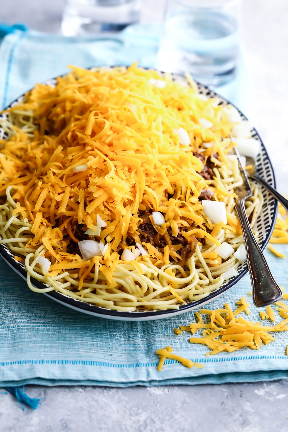 Cincinnati chili on a black and white serving platter.