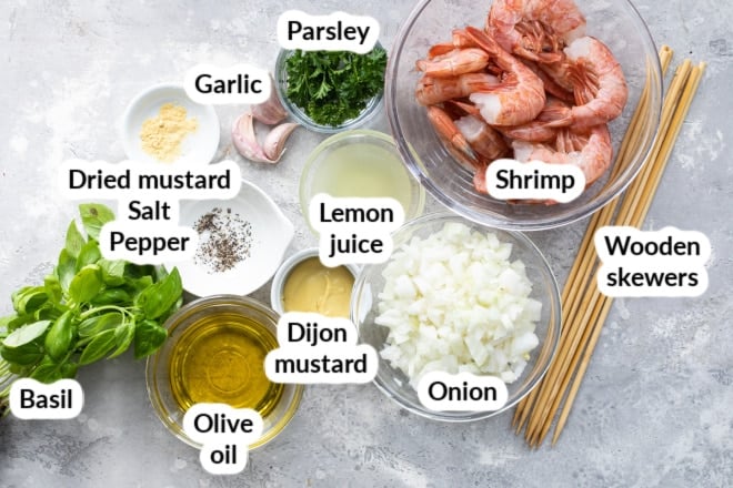 Labeled grilled shrimp skewer ingredients in various bowls.