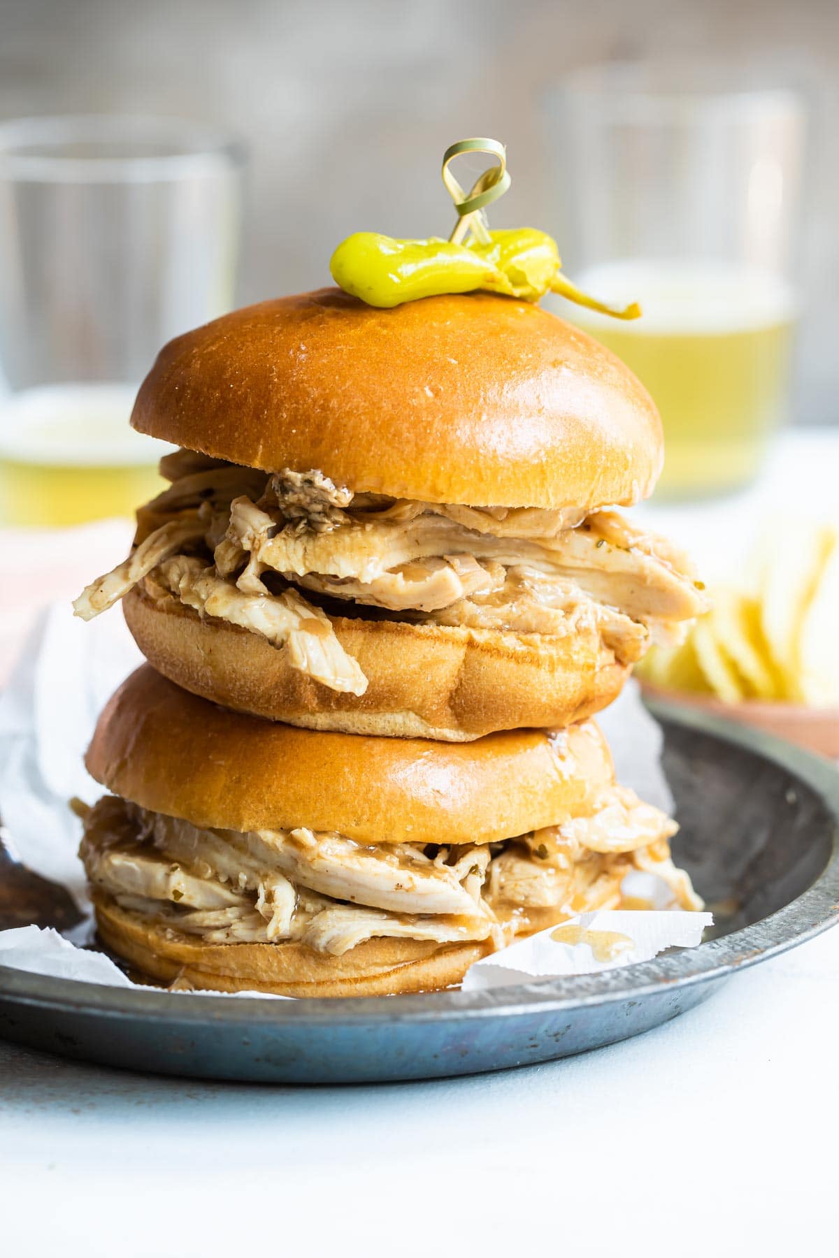 2 hot turkey sandwiches piled on a plate.
