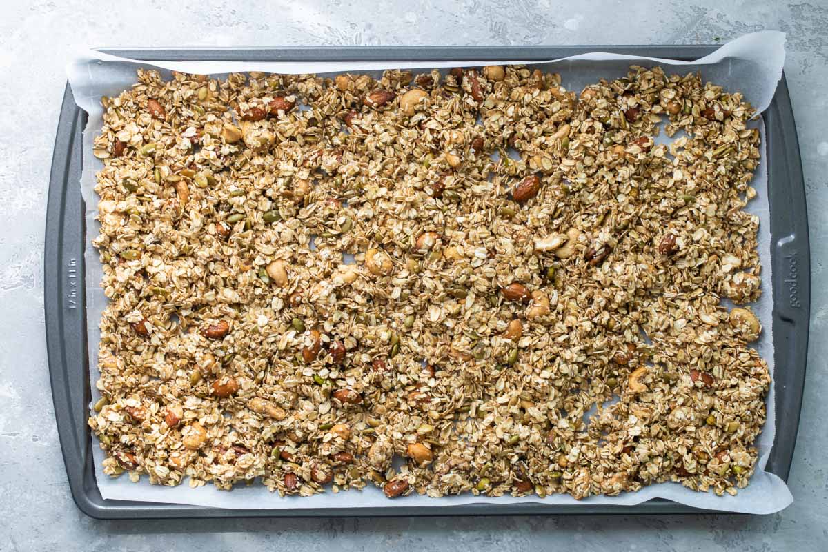 Granola on a baking sheet before being baked.