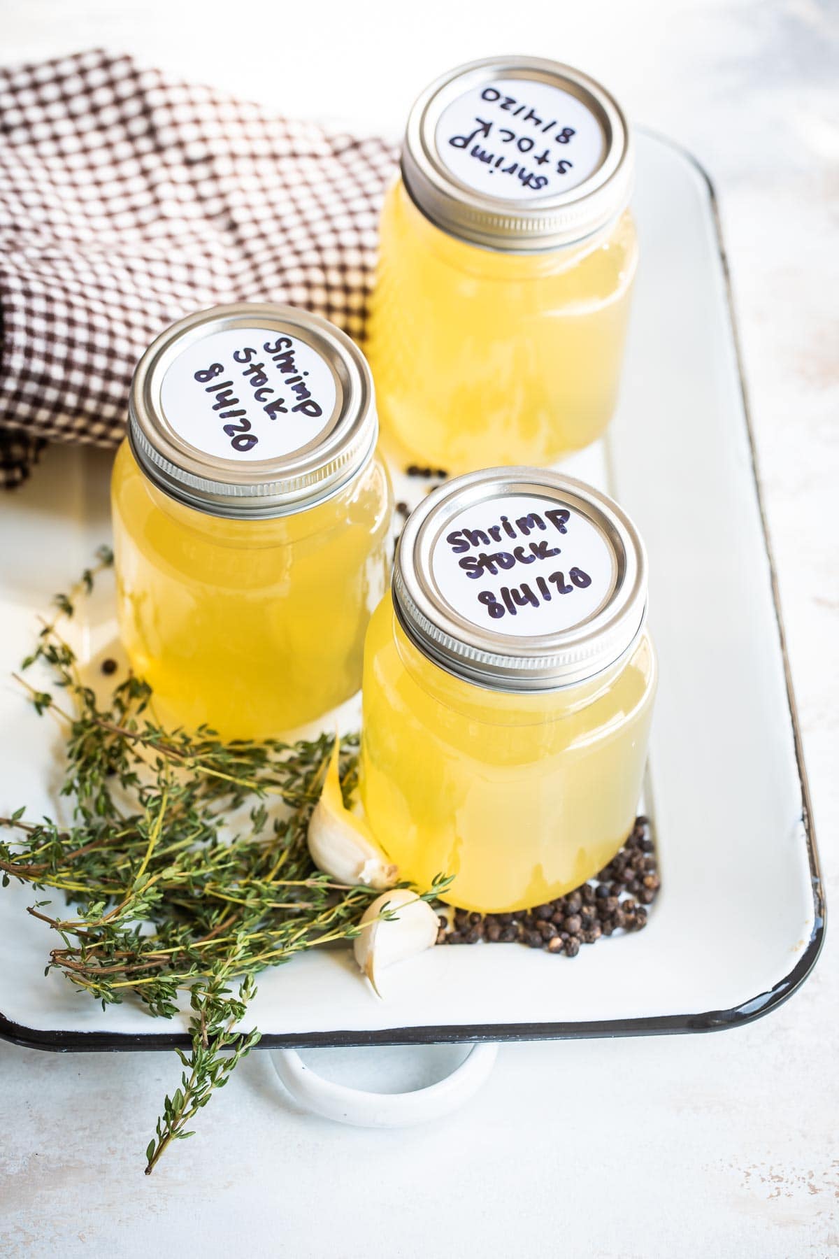 Shrimp stock labeled in three mason jars.