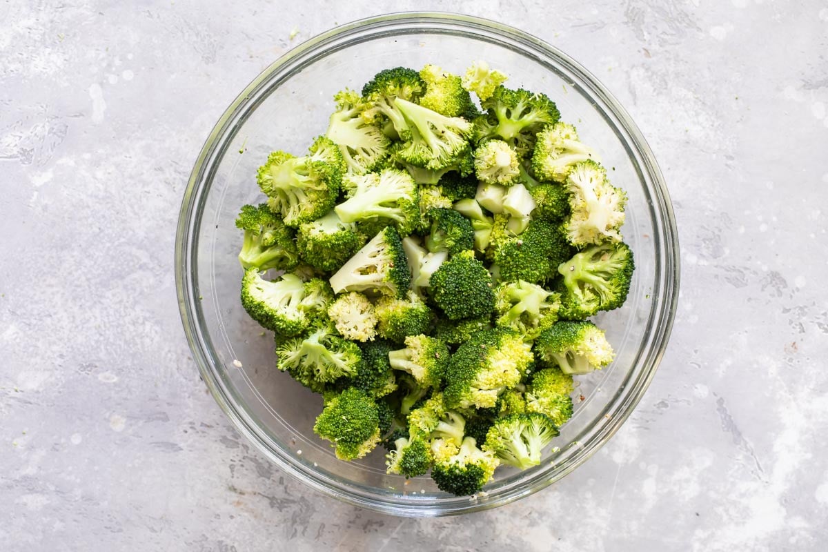 Raw broccoli with lemon in a bowl.