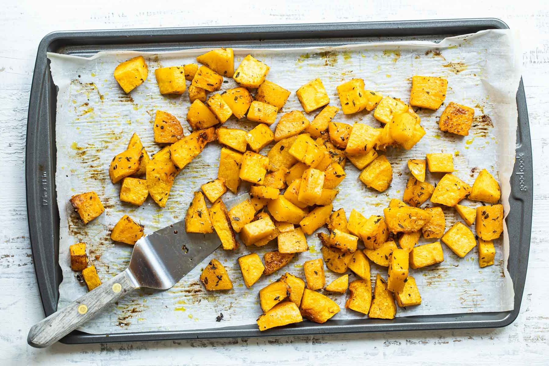 Roasted butternut squash on a baking sheet.