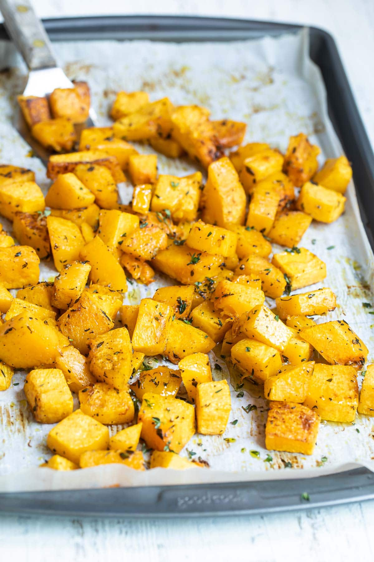 Roasted butternut squash on a baking sheet.