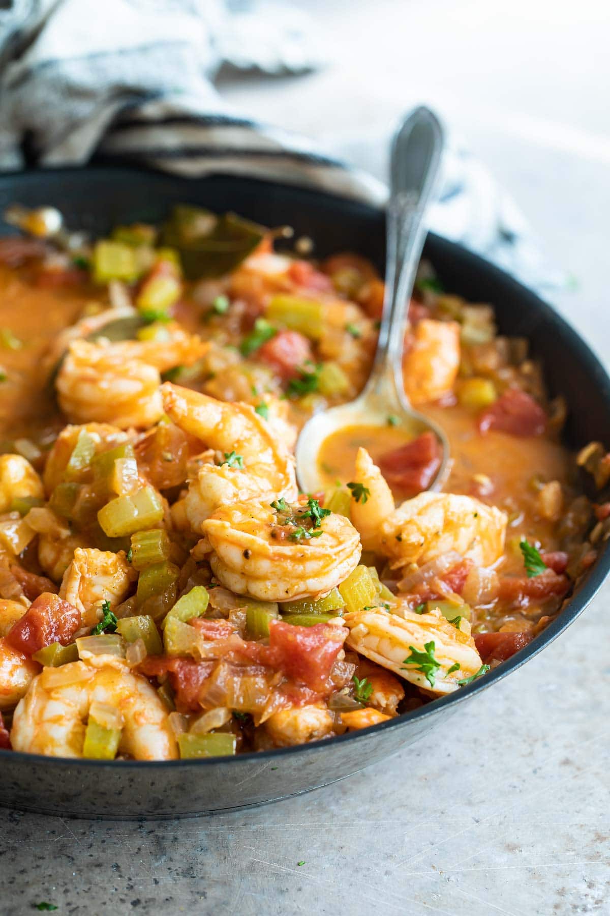Shrimp creole in a black bowl.