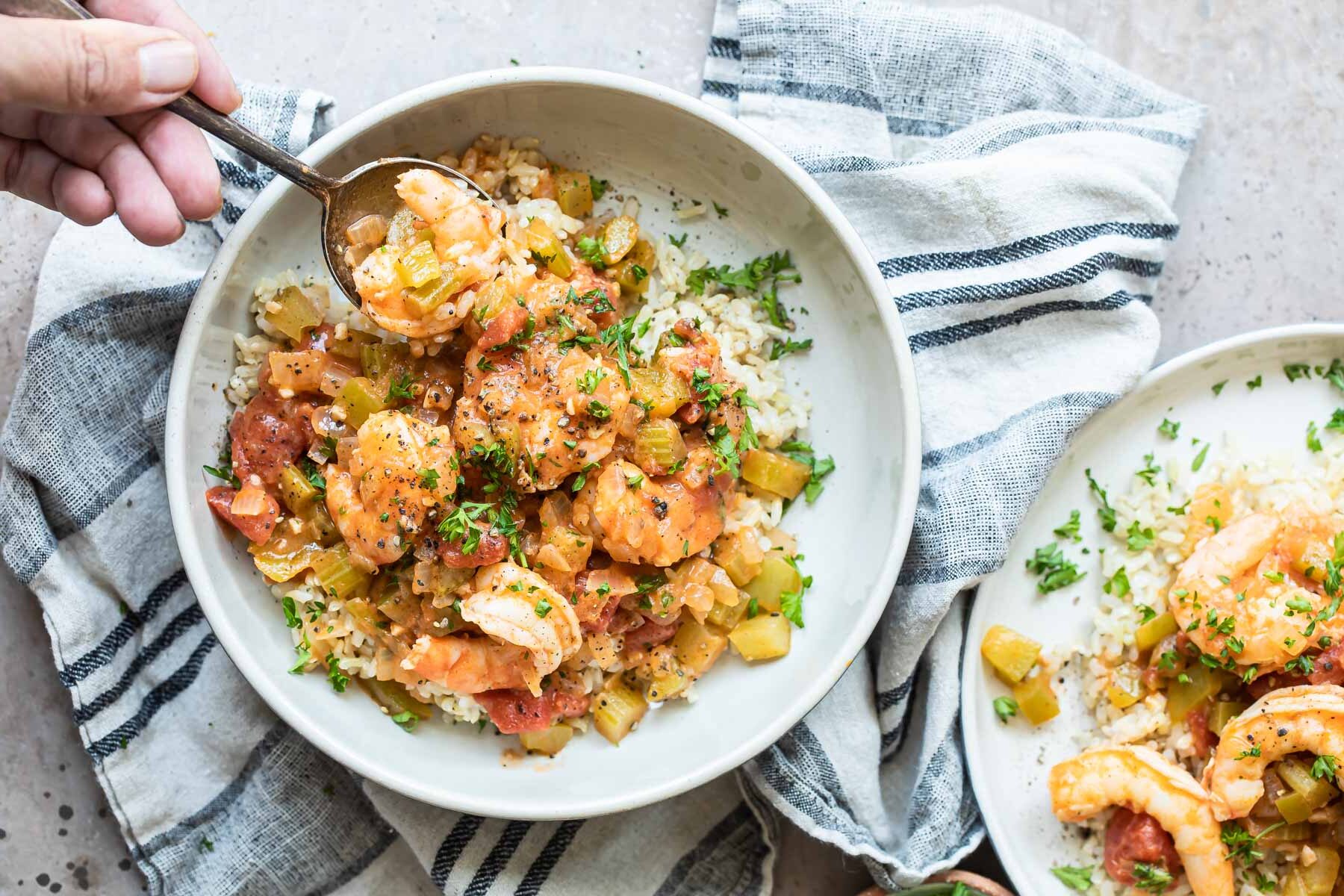Shrimp creole in a white bowl served over rice.