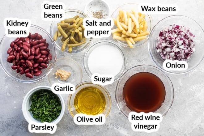Labeled ingredients for three bean salad in various bowls.