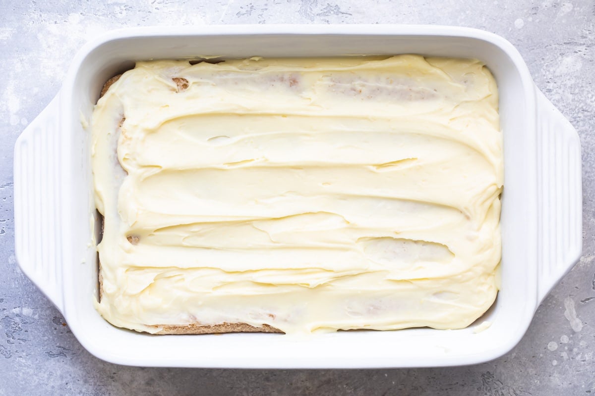 Mascarpone filling spread over lady fingers.