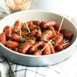 Barbecue little smokies in a white bowl.