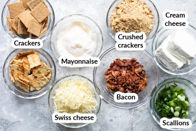 Cheesy bacon dip ingredients in various bowls.