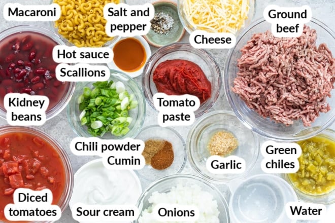 Labeled chili mac ingredients in various bowls.