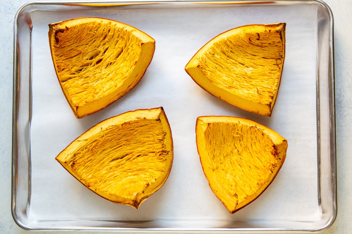 Fresh pumpkin roasted on a baking sheet.