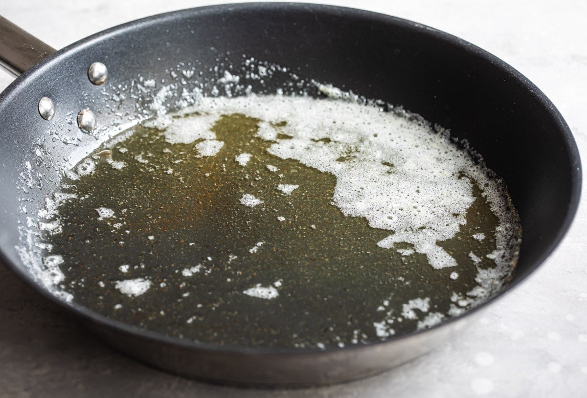 Melted butter in a pan to make roux.