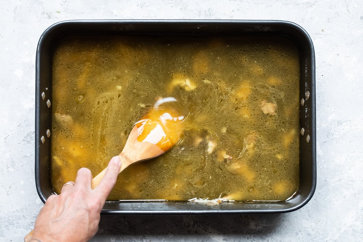 Pan drippings in a roasting pan for making gravy.