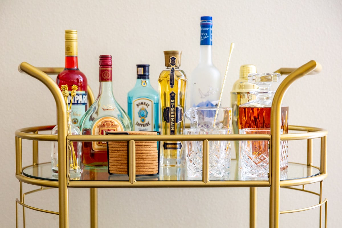 The top tier of a stocked bar cart.