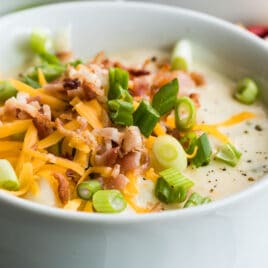 Loaded baked potato soup in a white bowl.