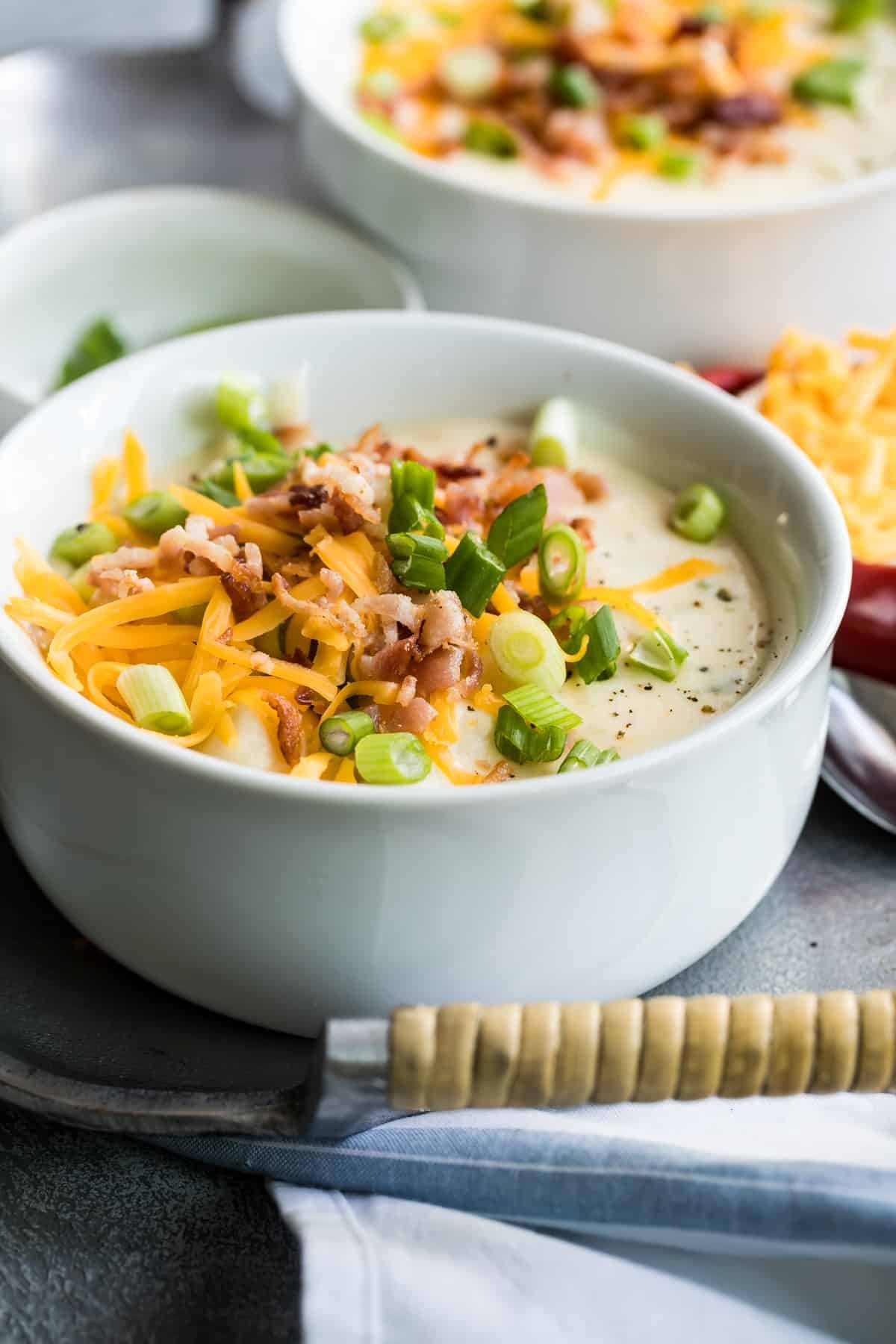 Loaded baked potato soup in a white bowl.