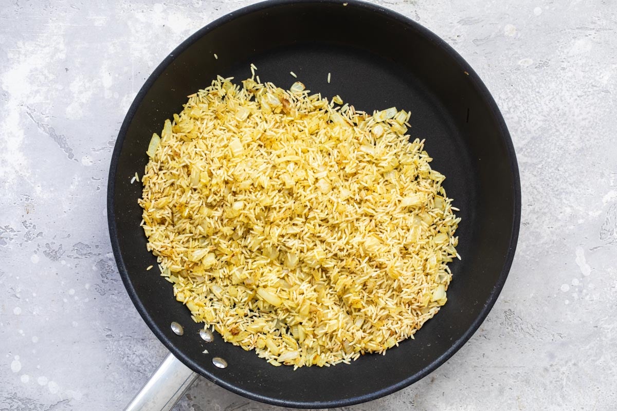 Rice toasting in a skillet.