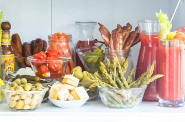 A bloody mary bar set up on a countertop.
