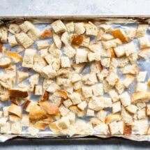 Cubes of bread on a baking sheet to try out for stuffing.