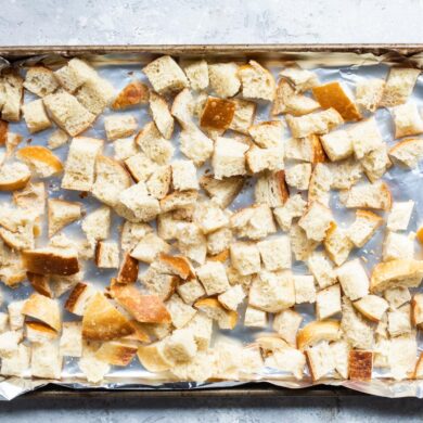 Cubes of bread on a baking sheet to try out for stuffing.