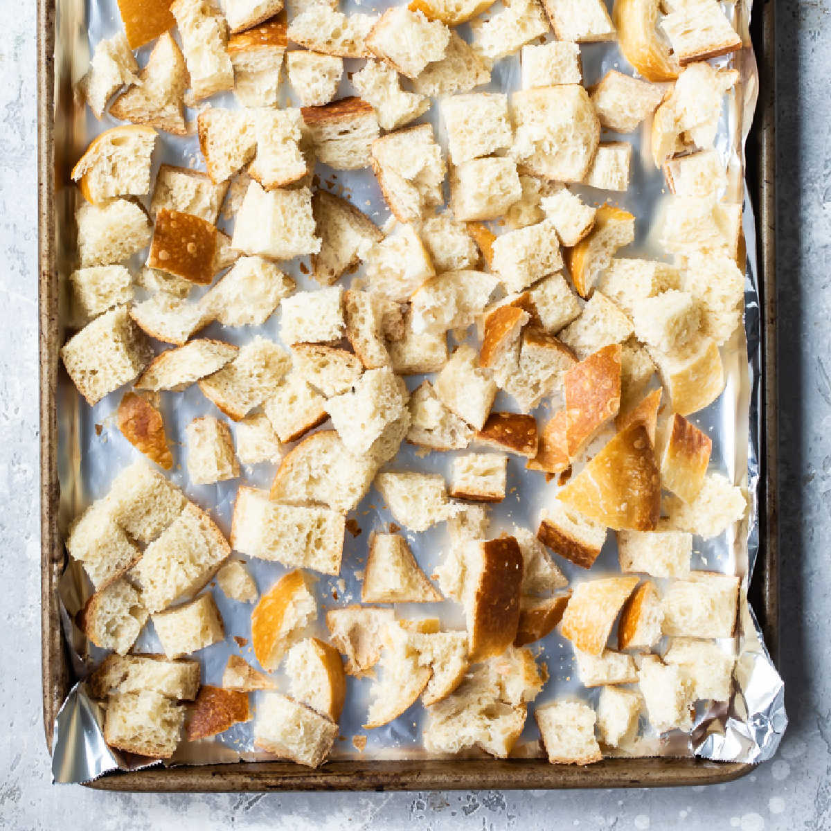 Cubes of bread on a baking sheet to try out for stuffing.