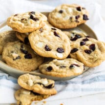Cranberry cookies with white chocolate on a gray plate.