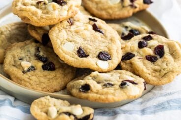 Cranberry cookies with white chocolate on a gray plate.