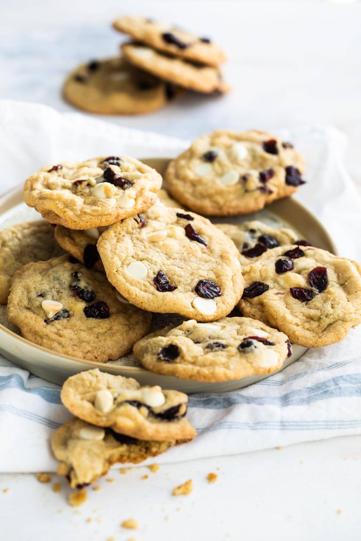 Cranberry cookies with white chocolate on a gray plate.