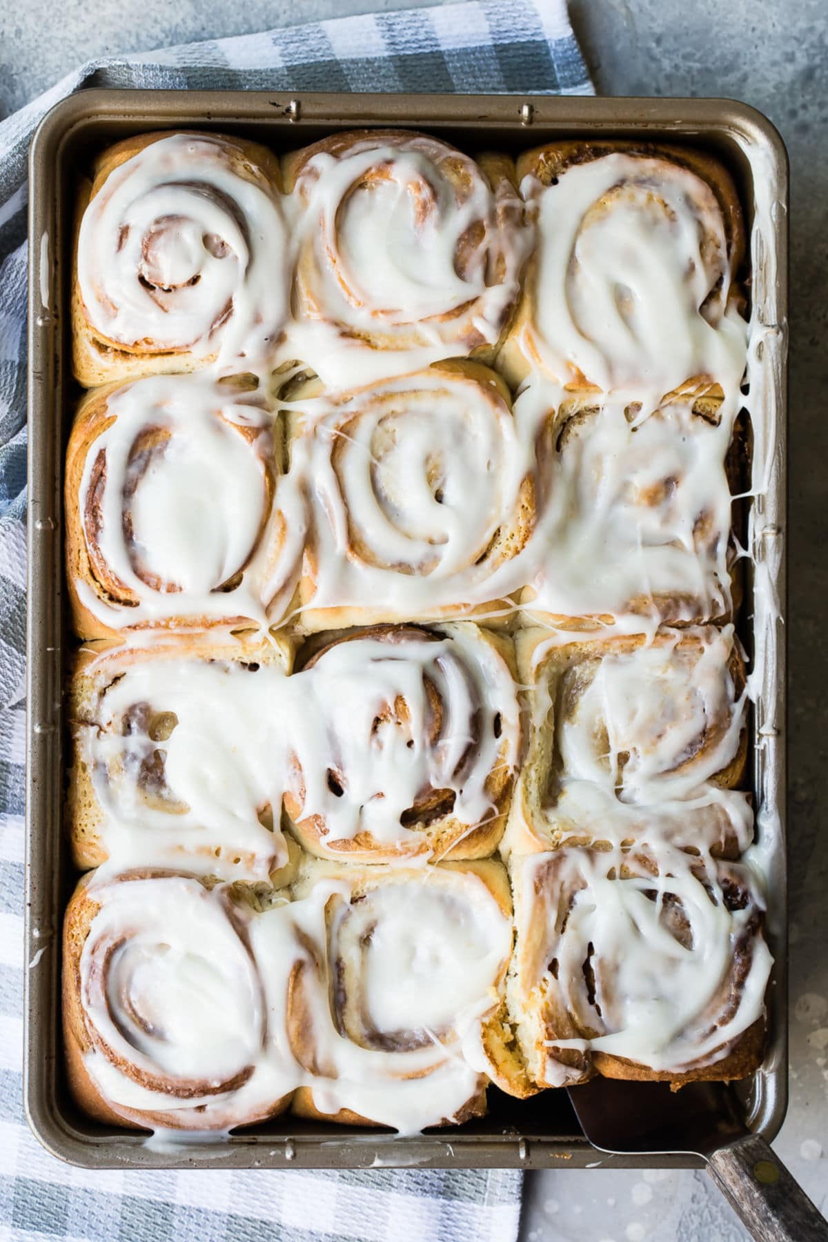 Homemade cinnamon rolls on a baking sheet.