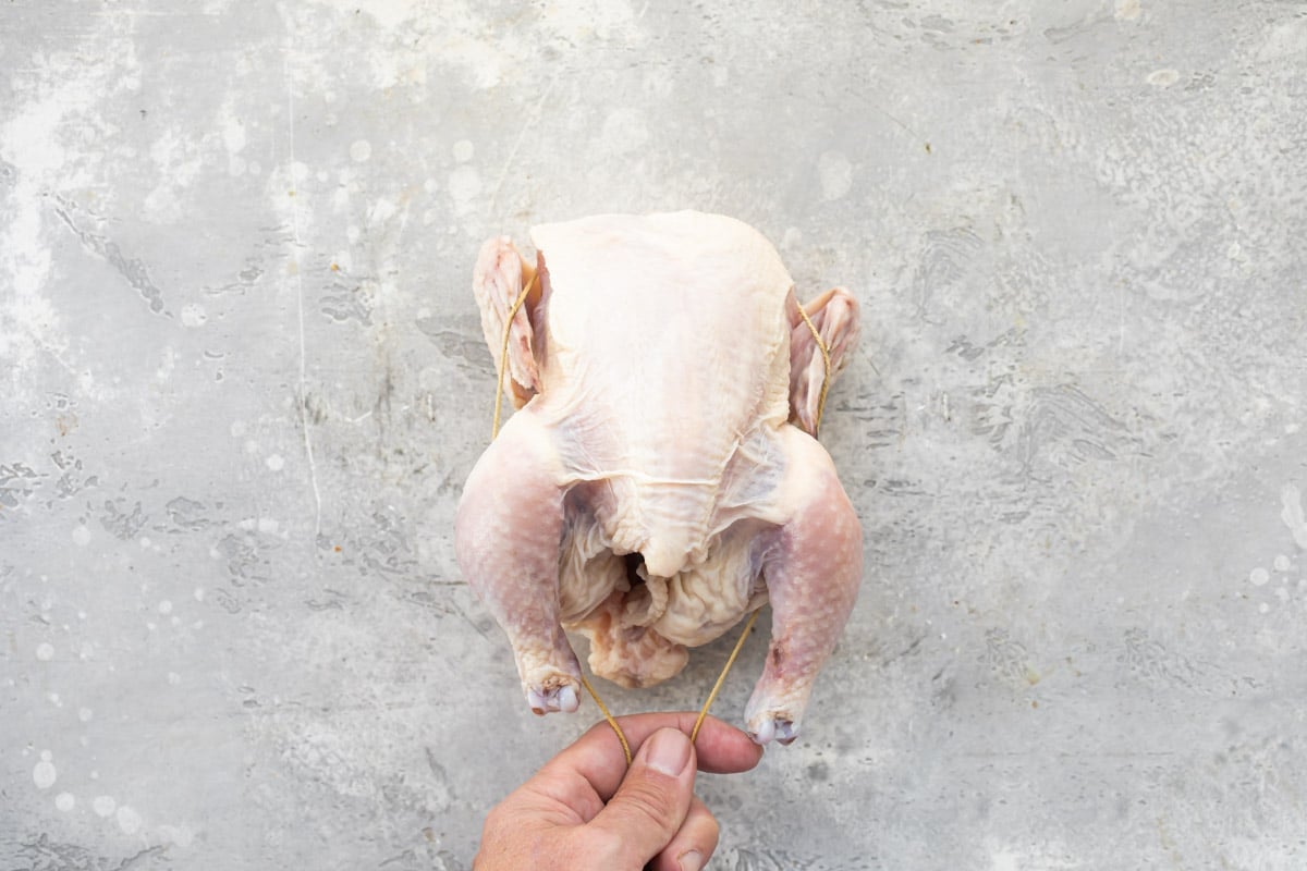 A Cornish hen being trussed.