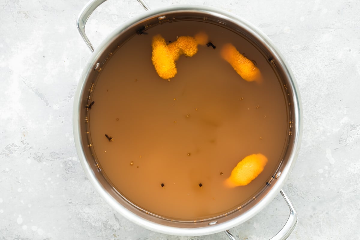 Mulled cider in a silver stock pot.