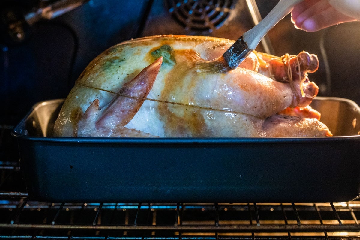 Basting a turkey roasting in the oven.