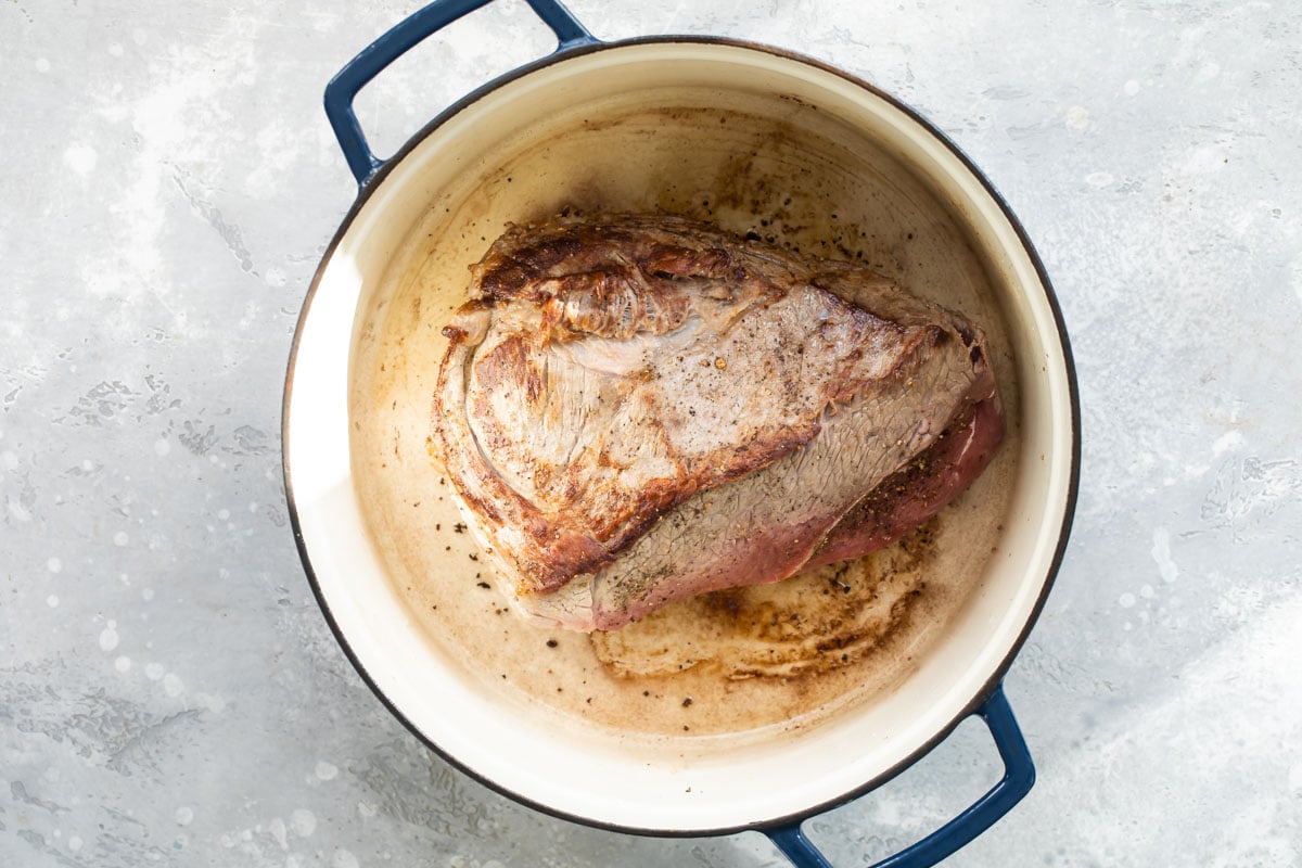 Pot roast browned in a dutch oven.