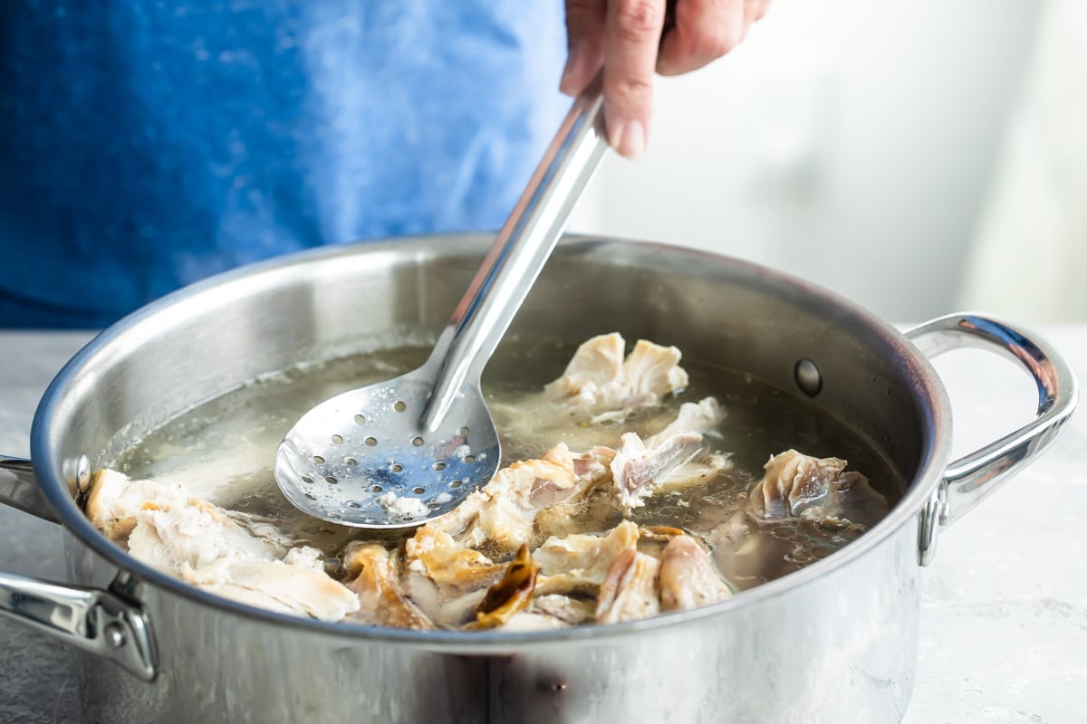 Skimming foam off turkey broth.