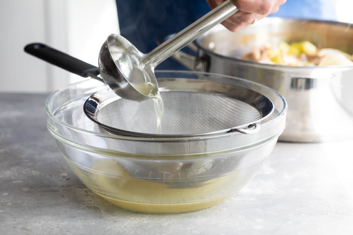 Straining turkey broth.